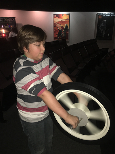 student holding spinning wheel